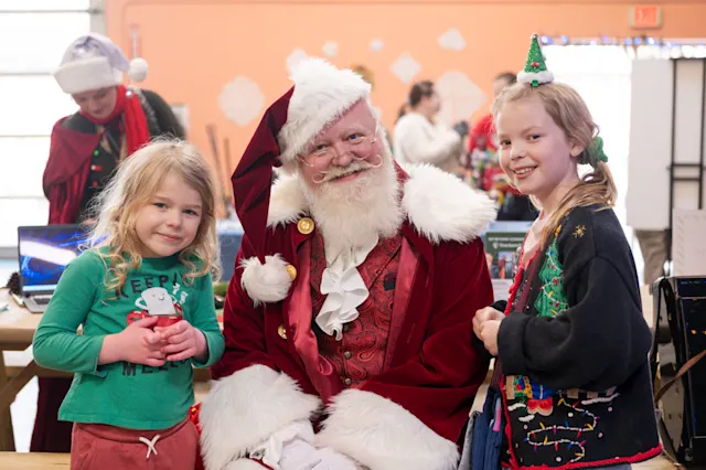 Santa with kids at the Trackers Holiday Faire