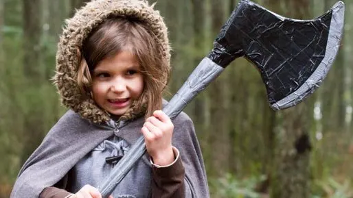 Kid learning axe throwing with a Trackers Guide