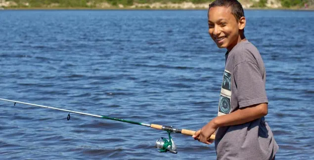 Young Tracker practicing casting at the lake