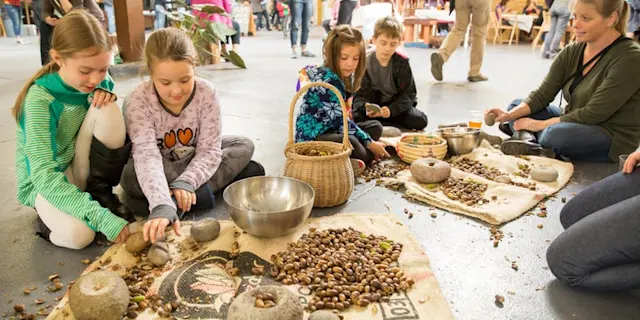 Kids and a Guide sorting acorns at Skills Night