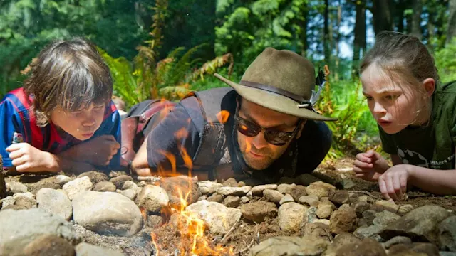 Kids learning fire skills at outdoor school