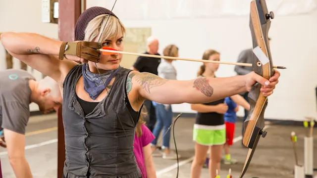A family learning archery together