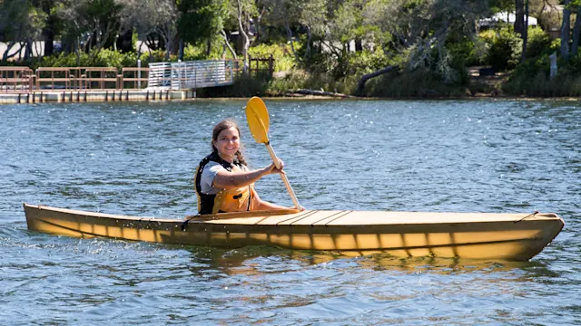 Summer camper paddling a kayak